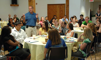 James Patton, Ph.D., standing, talks with incoming graduate students at last week’s orientation. (photo by Neil Brake)