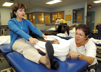 Julie Neaderthal, a physical therapist with Rehabilitation Services, checks German's foot during a recent appointment. German is confident she will run again.