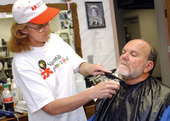 Emma Underwood gives Louis DeFelice, Ph.D., a beard trim during the first Cut-a-Thon held Monday at the Vanderbilt Hair Salon which raised $1,000. Judy Lee (not pictured) also cut hair during the fundraiser. Dana Johnson