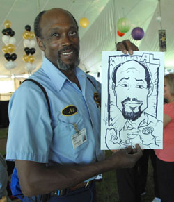 Plant Services’ Al Brown shows off his caricature. (photo by Neil Brake)
