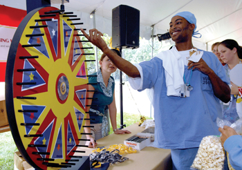 Surgical tech Richard Holt spins the wheel for a prize. (photo by Dana Johnson)