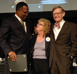Kevin Myatt, left, and Chancellor Gordon Gee pose with Jane Tugurian as she is honored for 40 years of service to Vanderbilt.