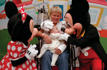 Minnie and Mickey Mouse visit with patient Jimmy Truman, 12, and his friend Skylar Bergey, five months.