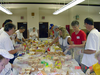 Red Cross volunteers assemble 2,500 peanut butter and jelly sandwiches to be delivered to local families in need.
