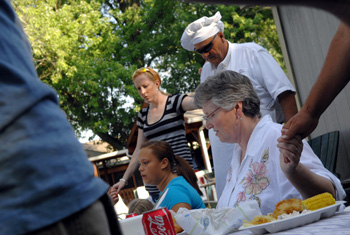 At a recent cookout, Crankshaw and her family pray before the meal. (photo by Dana Johnson)
