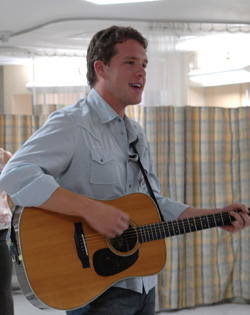 Matt Jenkins plays a tune while visiting patients at VUH. (photo by Neil Brake)