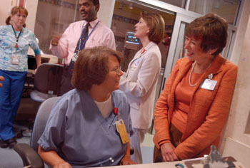 Interactive leadership is a hallmark of Chief Nursing Officer Marilyn Dubree’s Vanderbilt career. Here she chats with Martha Bland, R.N., during rounds in the NICU with other administrators. 
Photo by Dana Johnson
