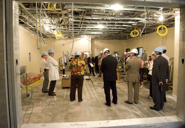 Hospital administrators tour an 1,100-square-foot operating room, designed to accommodate advanced imaging equipment. (photo by Joe Howell)