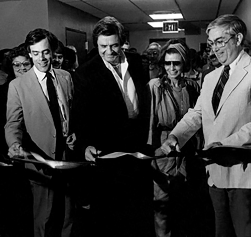 Johnny Cash and June Carter Cash, flanked by Norman Urmy, left, and Anderson Spickard Jr., M.D., at the ribbon cutting to open the Vanderbilt Institute for the Treatment of Alcoholism (VITA) on June 26, 1984. (file photo by Debbie Meredith).